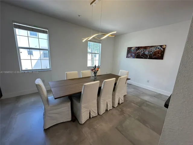 a living room with furniture a window and a flat screen tv