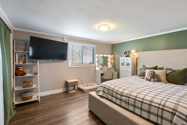 255 North 1600 West, Unit 60 Provo, UT 84601 - Photo 8 of 22 Bedroom with dark wood finished floors, a textured ceiling, and crown molding