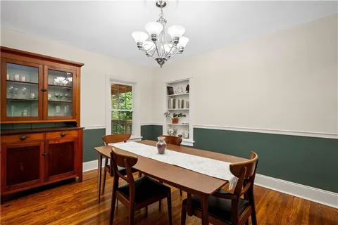 a view of a dining room with a table and chairs