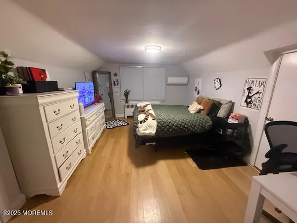 a bedroom with furniture and a dresser