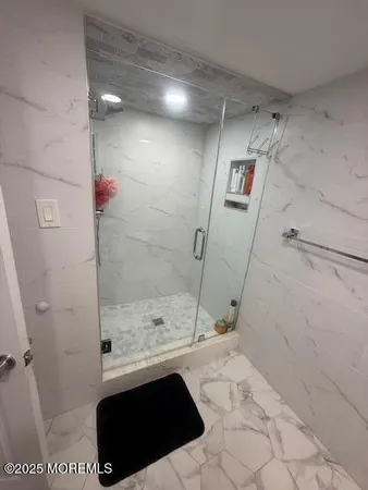 a bathroom with a bathtub and shower