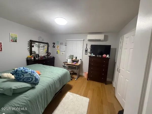 a bedroom with a bed and a tv