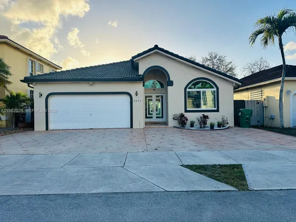 a front view of a house with a yard and garage