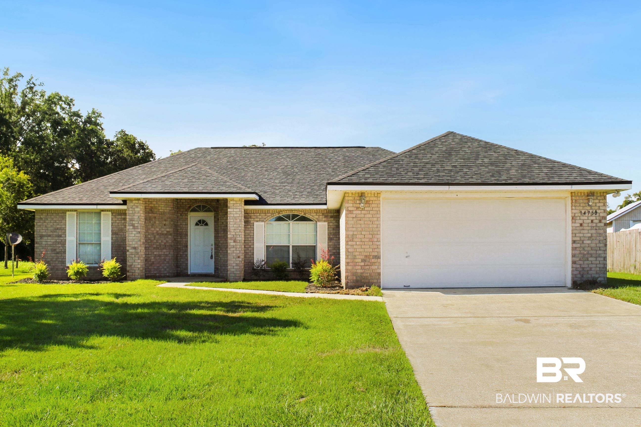 14750 Pawnee Court Foley, AL 36535 - Photo 1 of 34 Single story home featuring a shingled roof, brick siding, driveway, and a garage