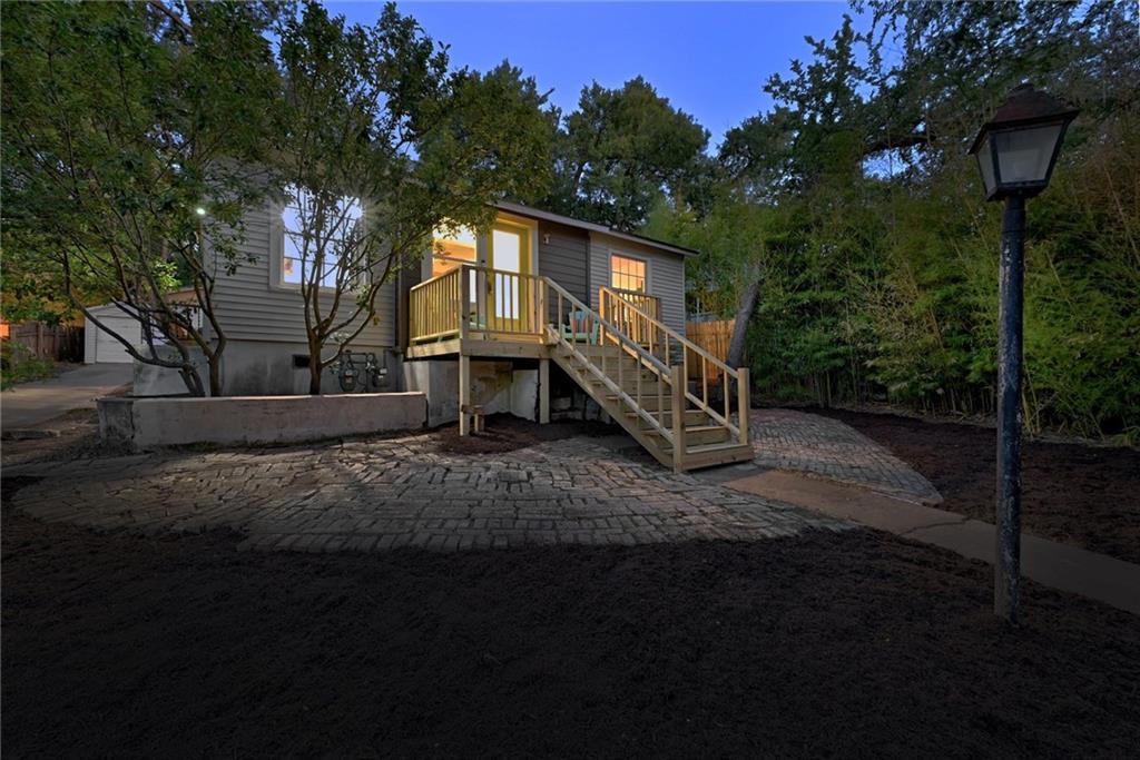 3207 Breeze Terrace, Unit A Austin, TX 78722 - Photo 18 of 18 View of front facade featuring a patio area and stairway. Driveway to the left accommodates two vehicles.