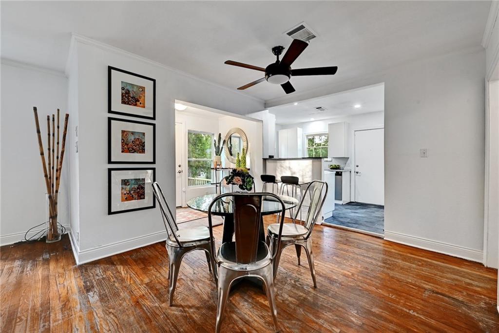 3207 Breeze Terrace, Unit A Austin, TX 78722 - Photo 4 of 18 Dining space with dark wood finished floors, a ceiling fan, and crown molding