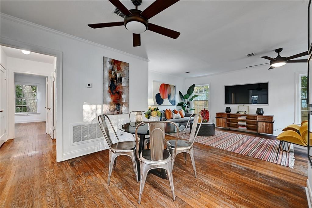 3207 Breeze Terrace, Unit A Austin, TX 78722 - Photo 5 of 18 Dining room with ceiling fan, hardwood / wood-style flooring, and ornamental molding