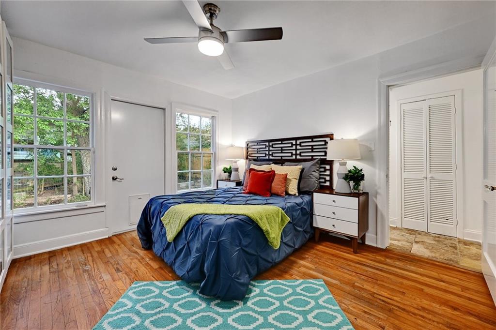 3207 Breeze Terrace, Unit A Austin, TX 78722 - Photo 10 of 18 Bedroom featuring hardwood / wood-style flooring and a ceiling fan