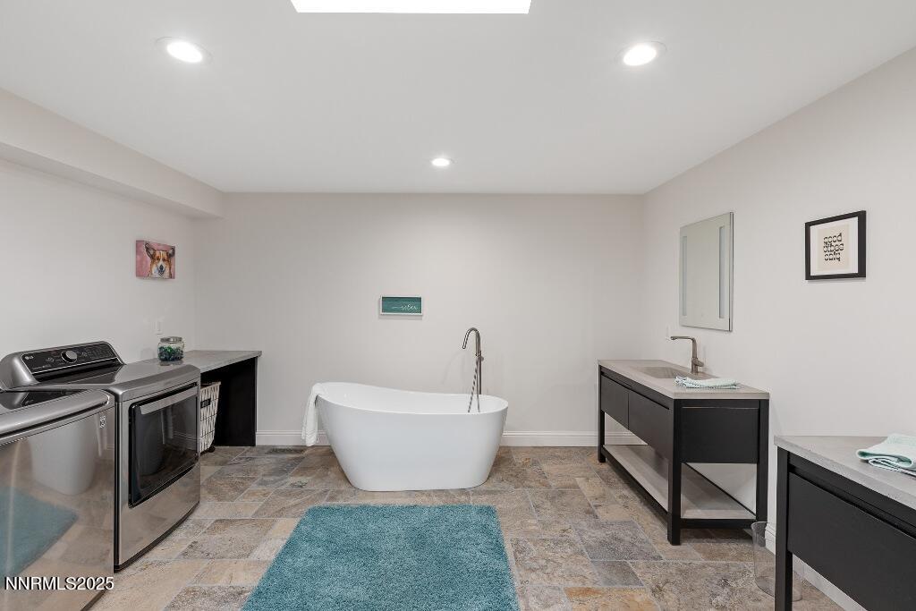 4811 Lakeridge Terrace West Reno, NV 89509 - Photo 27 of 43 a spacious bathroom with a toilet sink and mirror