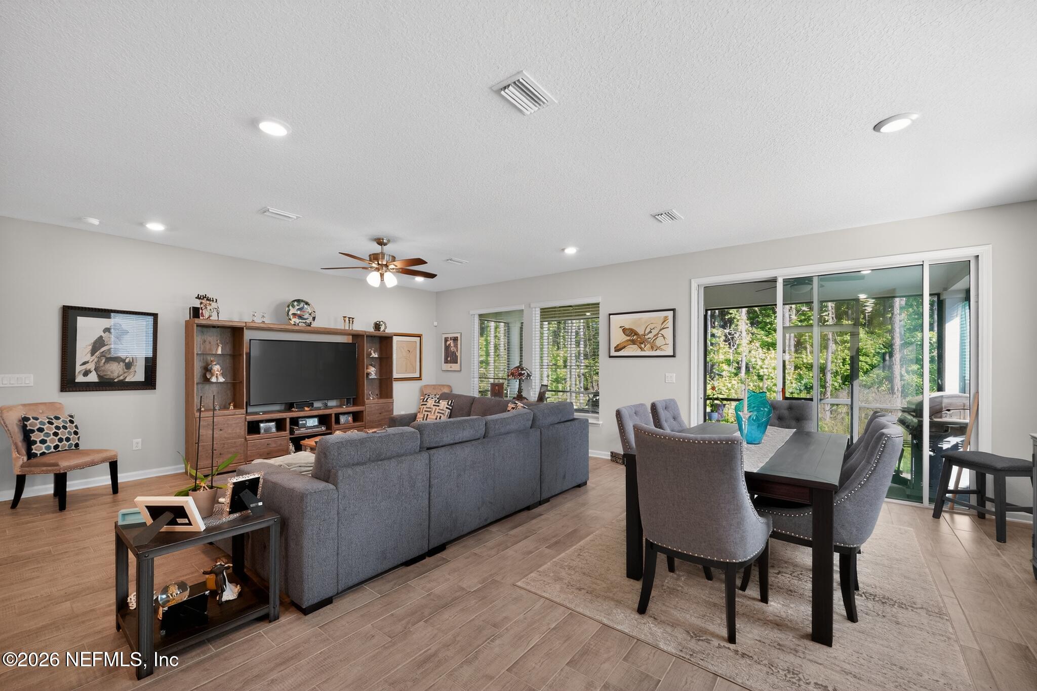 75505 Banyan Way Yulee, FL 32097 - Photo 14 of 30 a living room with furniture a flat screen tv and a large window