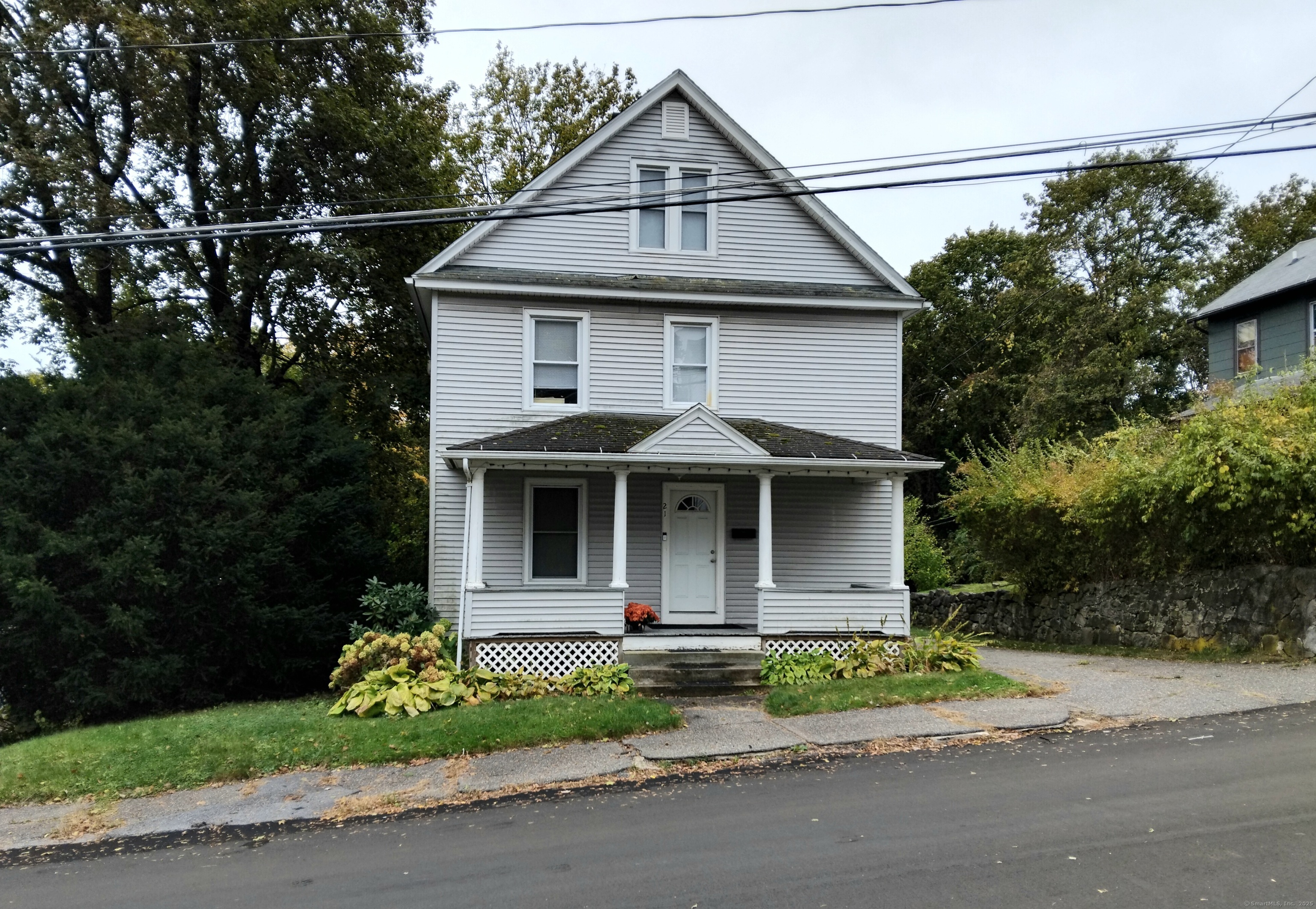 21 Roosevelt Avenue Torrington, CT 06790 - Photo 2 of 22 a front view of a house with a yard and garage