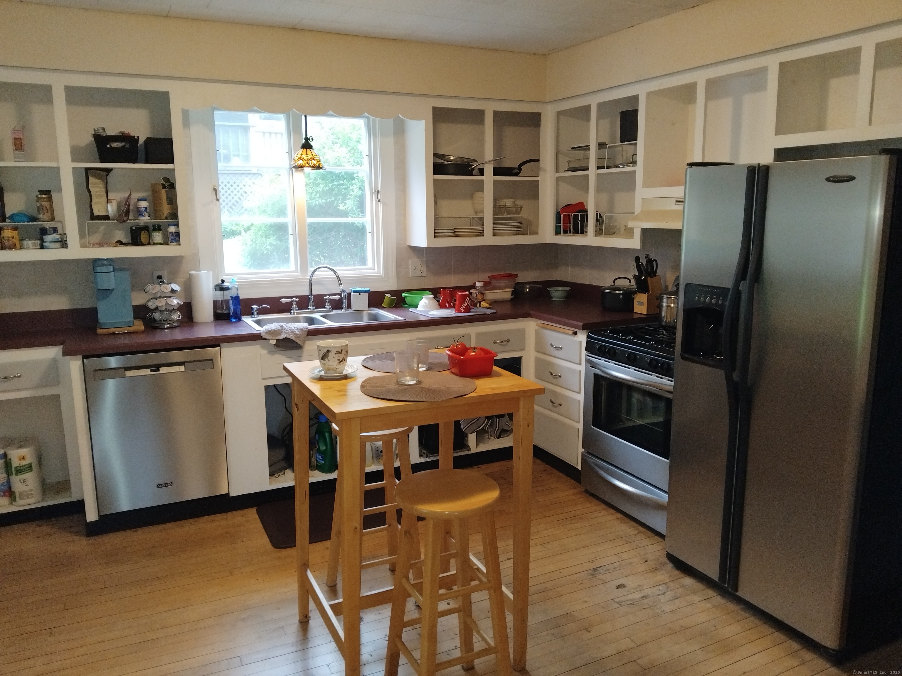21 Roosevelt Avenue Torrington, CT 06790 - Photo 8 of 22 a kitchen with a stove a refrigerator and a dining table