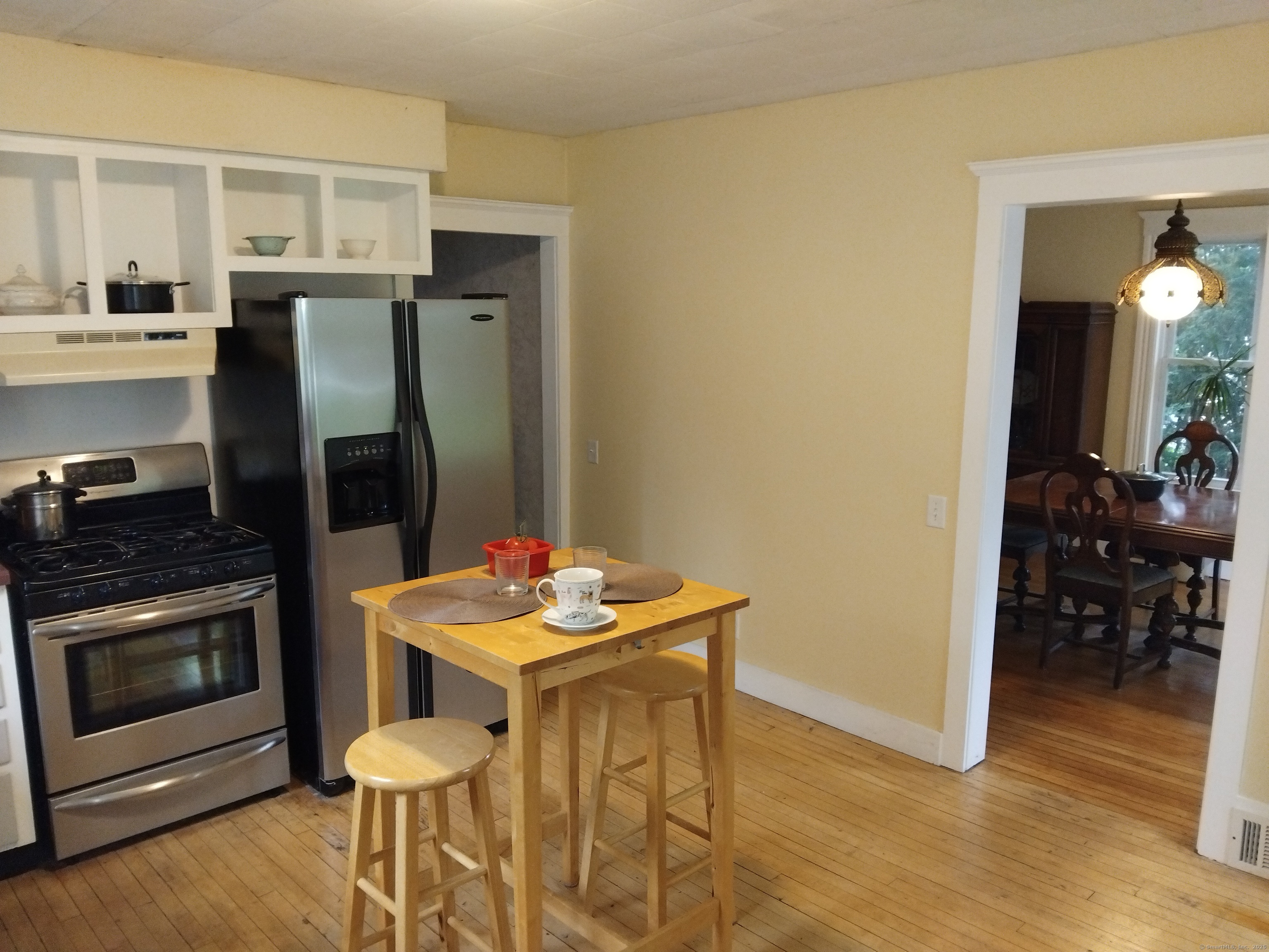 21 Roosevelt Avenue Torrington, CT 06790 - Photo 9 of 22 a kitchen with stainless steel appliances kitchen island granite countertop a refrigerator a stove and white cabinets with wooden floor