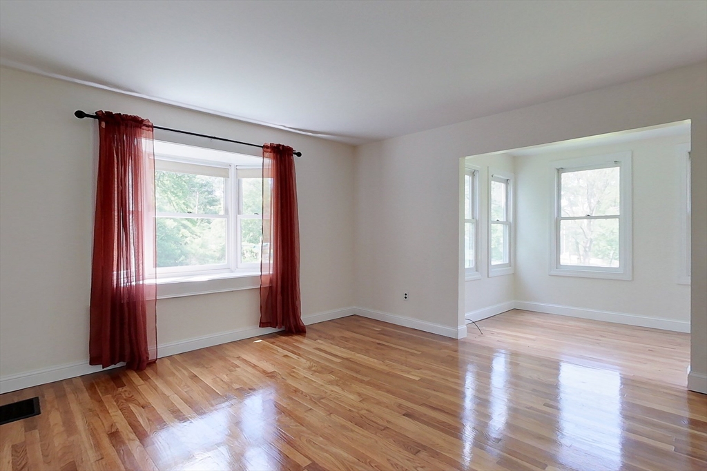 92 Squannacook Road Shirley, MA 01464 - Photo 12 of 38 an empty room with wooden floor and windows