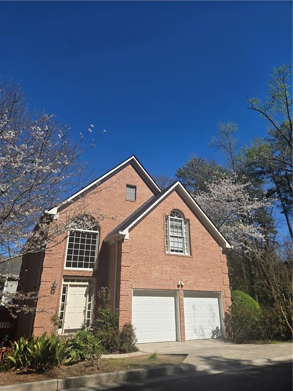 1209 Wildcliff Circle, Unit 100 Atlanta, GA 30329 - Photo 1 of 21 a front view of a house with a yard