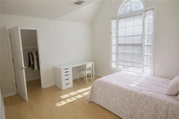 a bedroom with a bed and a window