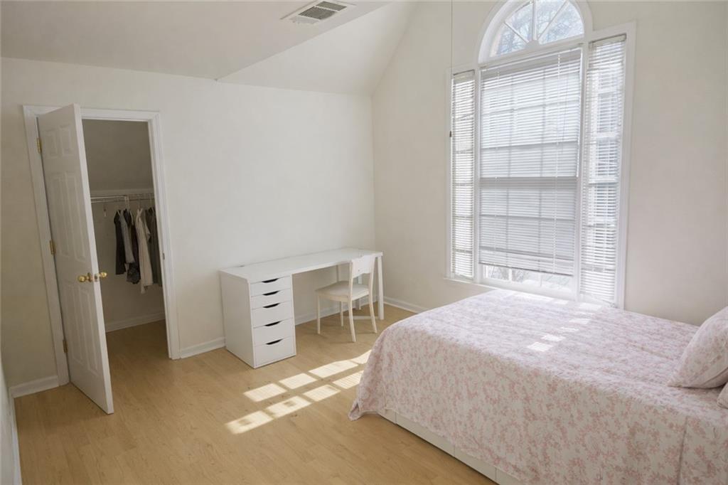 1209 Wildcliff Circle, Unit 100 Atlanta, GA 30329 - Photo 11 of 21 a bedroom with a bed and a window