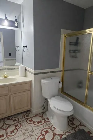 a bathroom with a toilet a sink and shower