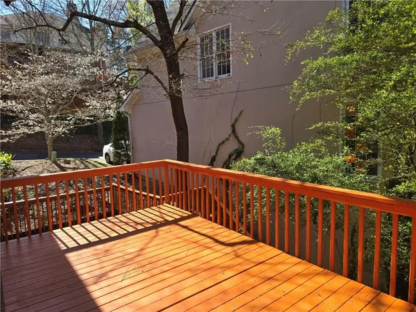 a view of balcony with wooden floor and fence