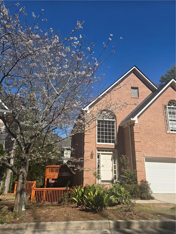 1209 Wildcliff Circle, Unit 100 Atlanta, GA 30329 - Photo 2 of 21 a front view of a house with yard