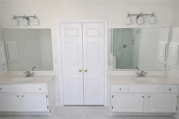 a bathroom with a double vanity sink mirror and