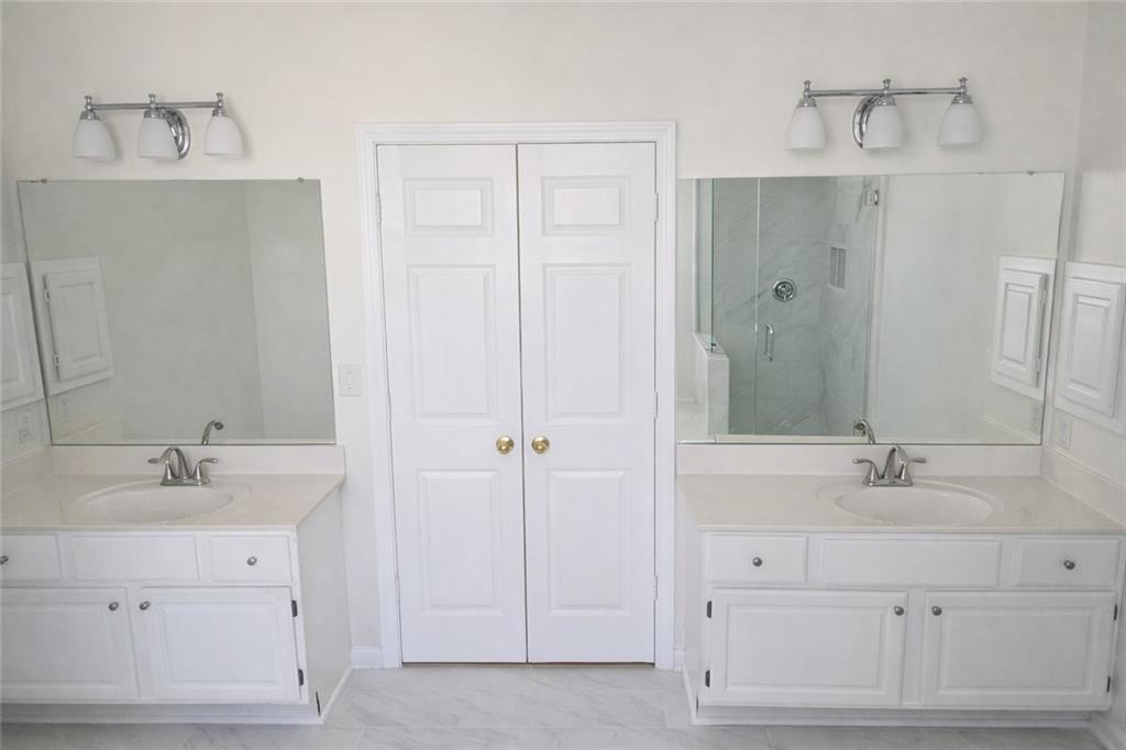 1209 Wildcliff Circle, Unit 100 Atlanta, GA 30329 - Photo 9 of 21 a bathroom with a double vanity sink mirror and