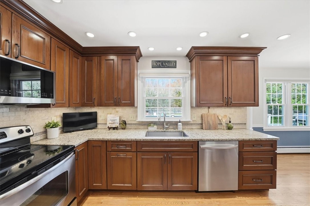 32 Lisa Lane Hopkinton, RI 02832 - Photo 12 of 50 This kitchen flows seamlessly into the sun-filled dining area and open living space, creating a true heart-of-the-home experience.