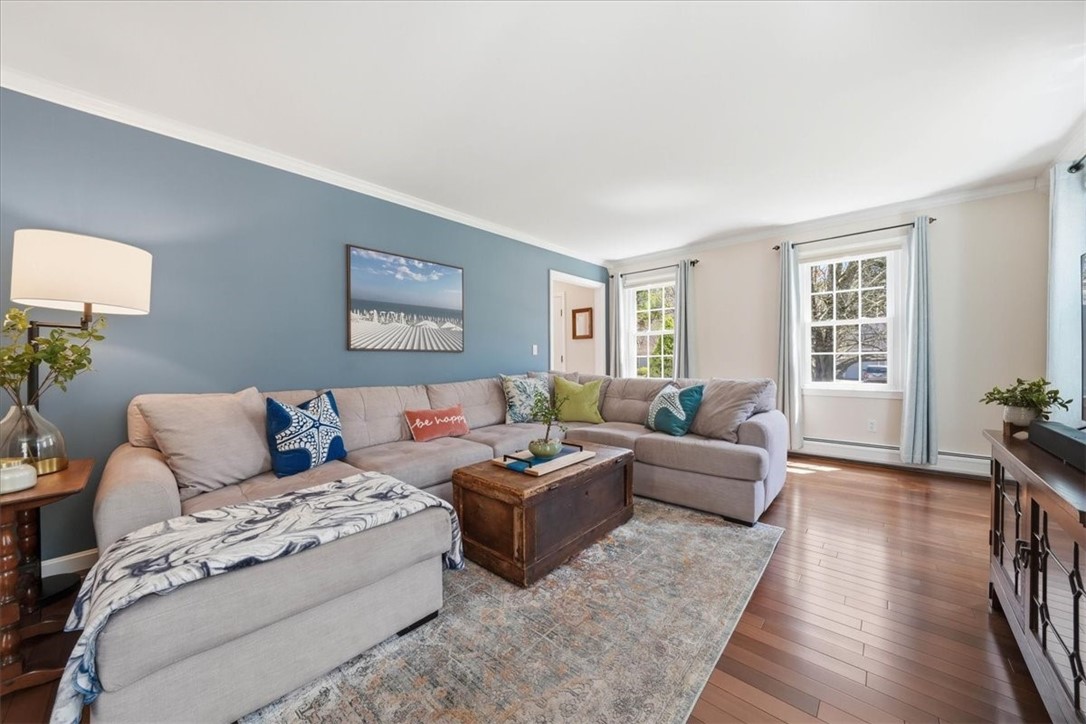 32 Lisa Lane Hopkinton, RI 02832 - Photo 20 of 50 A spacious living room showcases beautiful Brazilian redwood flooring, crown molding, and a light-filled layout.