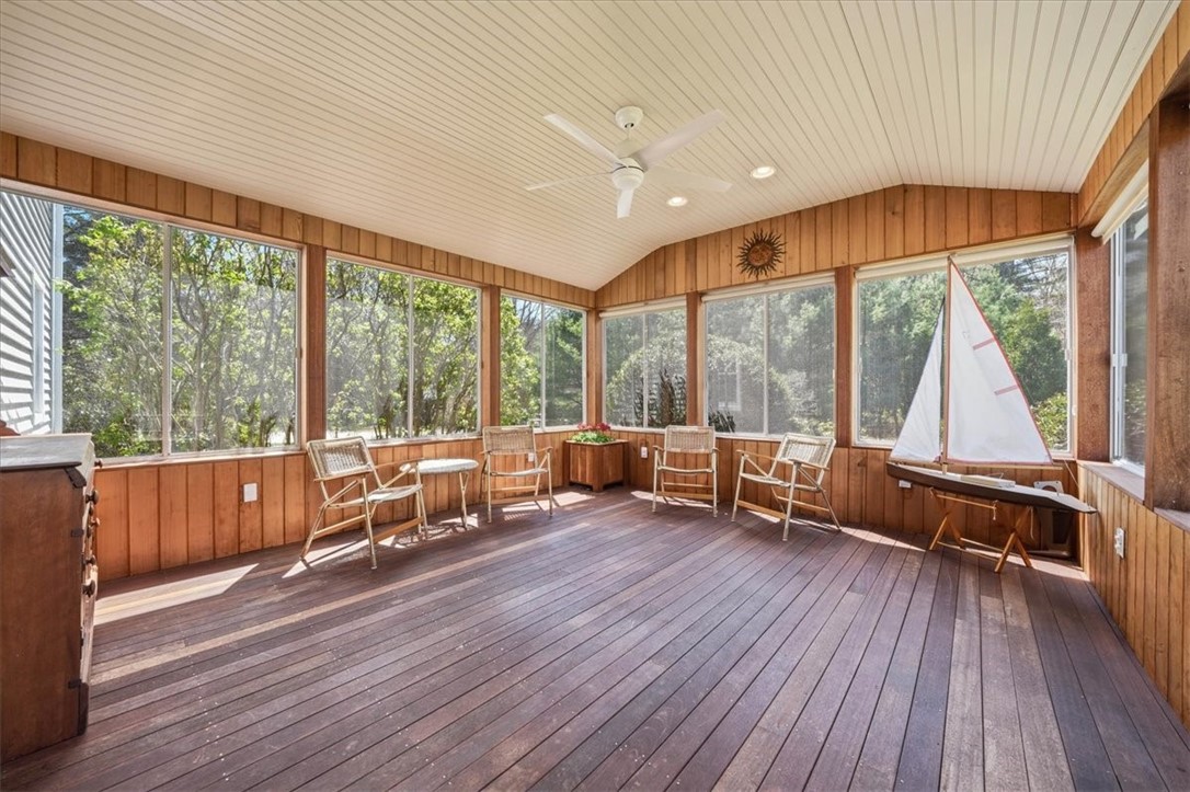 32 Lisa Lane Hopkinton, RI 02832 - Photo 22 of 50 A stunning, oversized 3-season room wrapped in warm cedar walls & rich mahogany flooring creates a true extension of the home’s living space.
