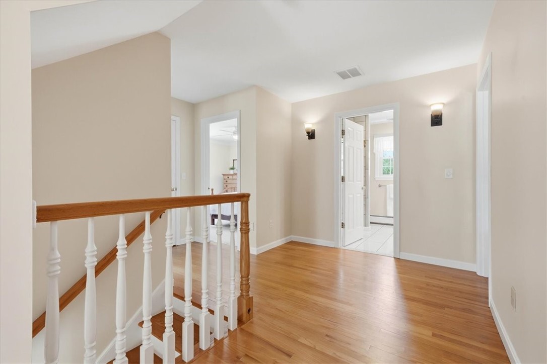 32 Lisa Lane Hopkinton, RI 02832 - Photo 24 of 50 Top of the spacious landing on the 2nd floor featuring extra wide hallways and gleaming hardwood floors.