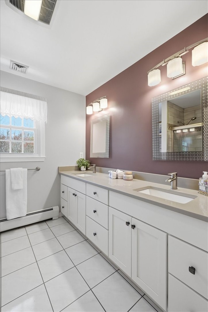 32 Lisa Lane Hopkinton, RI 02832 - Photo 25 of 50 The beautifully renovated 2nd-floor full bath blends style & function, featuring a spacious double vanity w/ a sleek solid surface countertop, updated fixtures & ample storage.