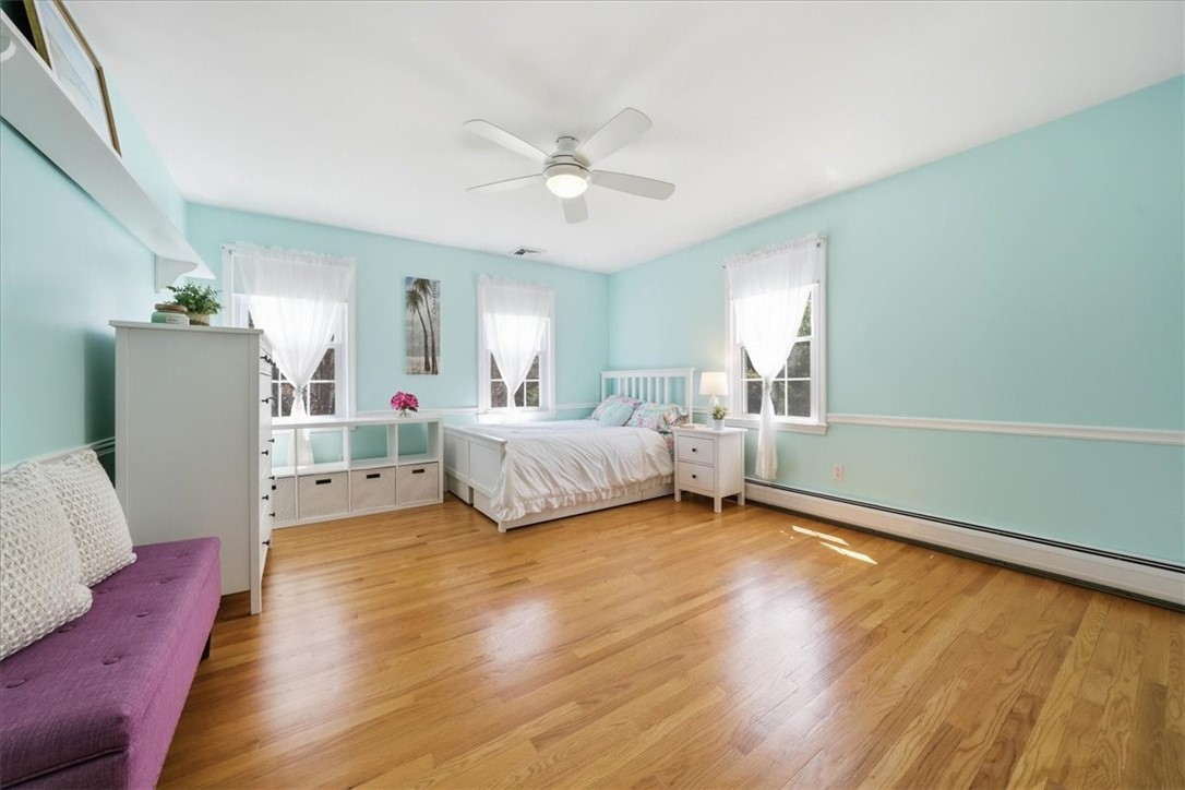 32 Lisa Lane Hopkinton, RI 02832 - Photo 27 of 50 A spacious, light-filled bedroom featuring beautiful hardwood flooring & a bright, open feel. Oversized double closets w/ custom closet systems provide exceptional storage, making this room both stylish & highly functional.