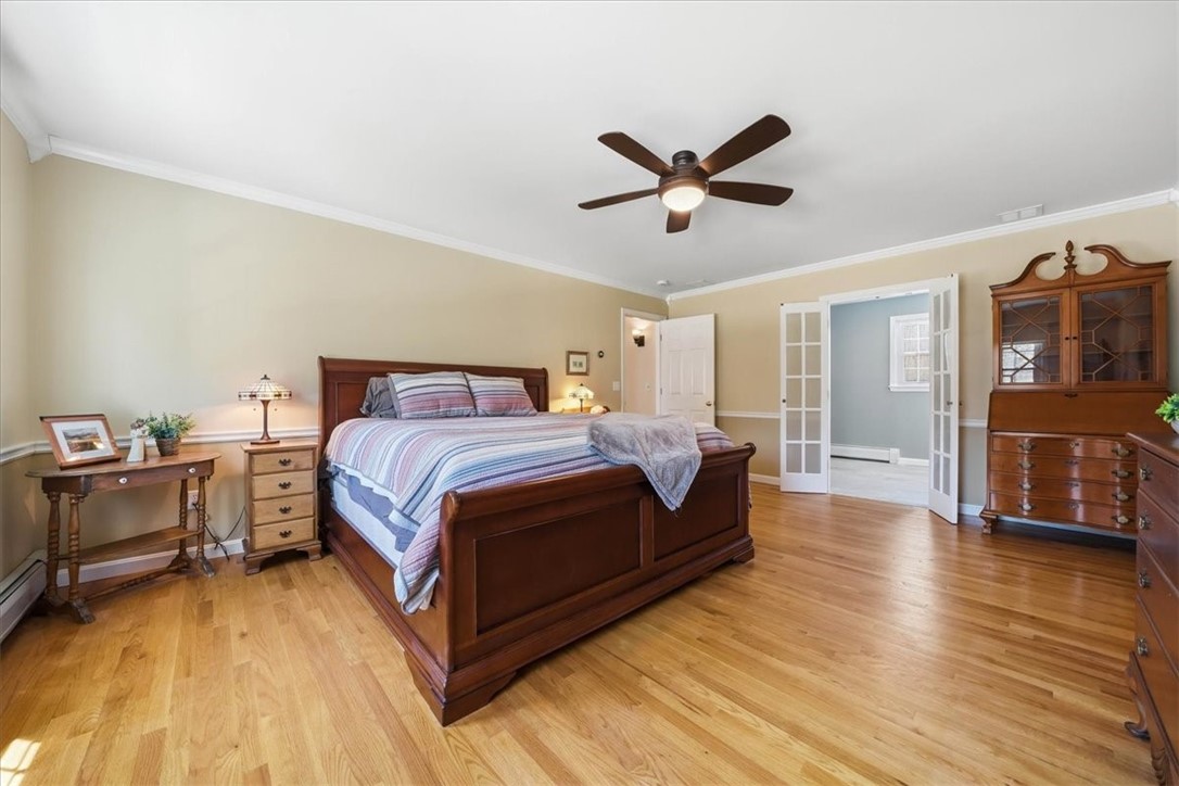 32 Lisa Lane Hopkinton, RI 02832 - Photo 30 of 50 A true sanctuary, this stunning primary suite offers exceptional scale, warmth & versatility. The spacious bedroom w/ hardwood floors is filled w/ natural light & easily accommodates both sleeping & lounging areas. Enjoy a beautifully renovated full bath, along w/ a remarkable dressing corridor featuring dual walk-in closets.