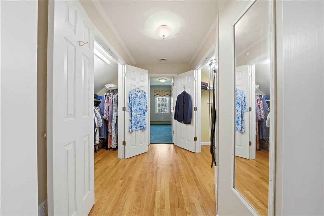 32 Lisa Lane Hopkinton, RI 02832 - Photo 34 of 50 The suite is complemented by a fully renovated bath & an impressive dressing hallway w/ two walk-in closets, providing exceptional storage & organization. Closets shown open.