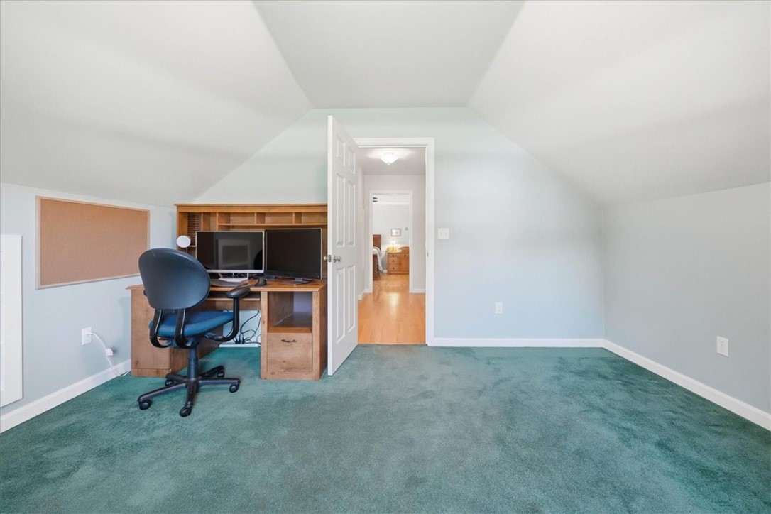 32 Lisa Lane Hopkinton, RI 02832 - Photo 37 of 50 This hidden bonus room adds incredible flexibility—perfect as a nursery, reading room, private office, yoga/fitness space or peaceful retreat. View of the bonus space looking into the dressing corridor with primary bedroom view in the background.