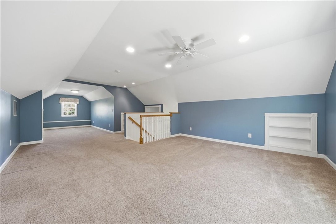 32 Lisa Lane Hopkinton, RI 02832 - Photo 40 of 50 Rarely do you find a bonus level this spacious, functional & full of potential! The finished attic space is bright, inviting & thoughtfully designed with custom built-ins, soft carpeting & multiple zones for living, working or relaxing