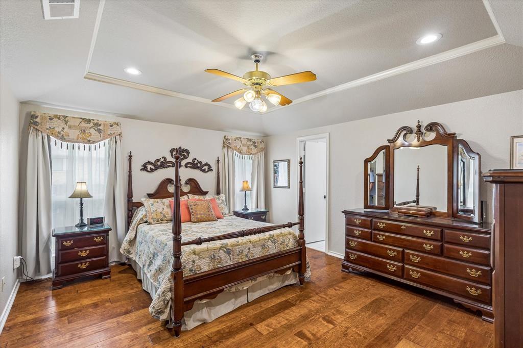 404 Moonlight Lane Keller, TX 76248 - Photo 20 of 40 a bedroom with a bed and a chandelier