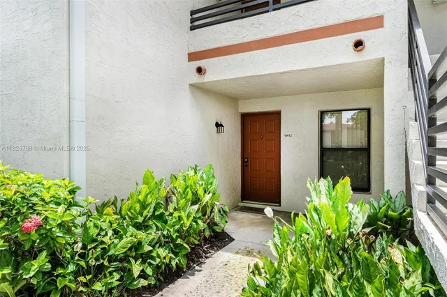 a front view of a house with flowers