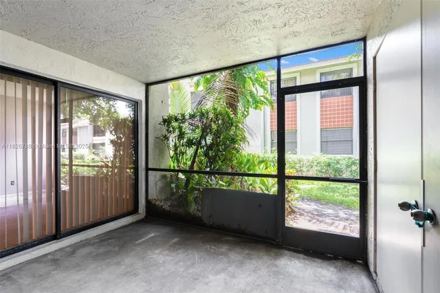 an empty room with floor to ceiling windows