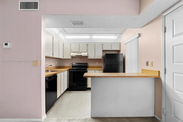 a kitchen with stainless steel appliances granite countertop a stove and a refrigerator