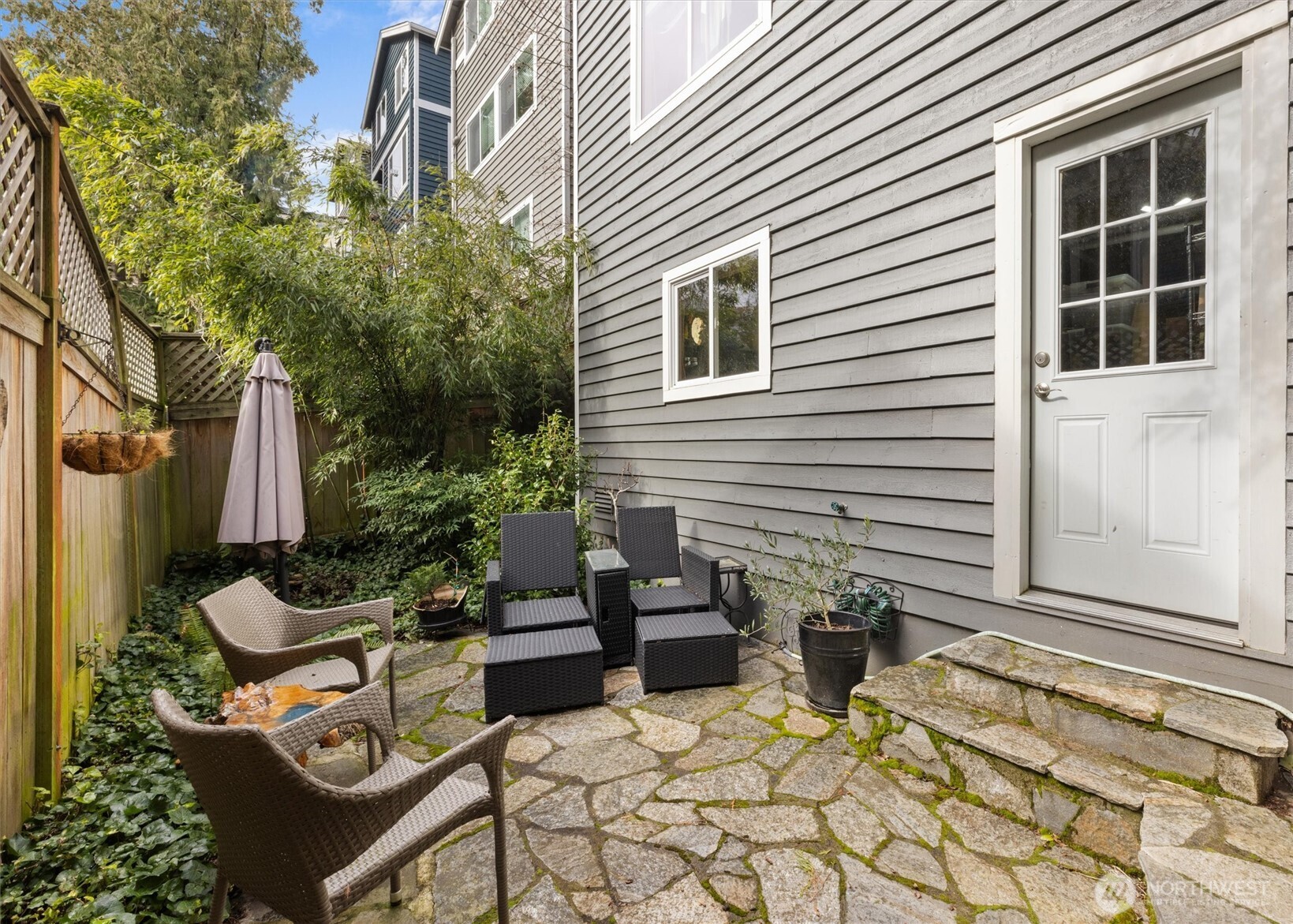 3414 33rd Avenue Southwest Seattle, WA 98126 - Photo 25 of 26 a view of a patio with couple of chairs and potted plants