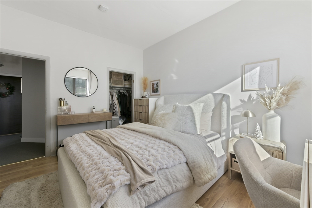 411 Marlborough Street, Unit 9 Boston, MA 02115 - Photo 11 of 20 a bedroom with a bed mirror and white walls