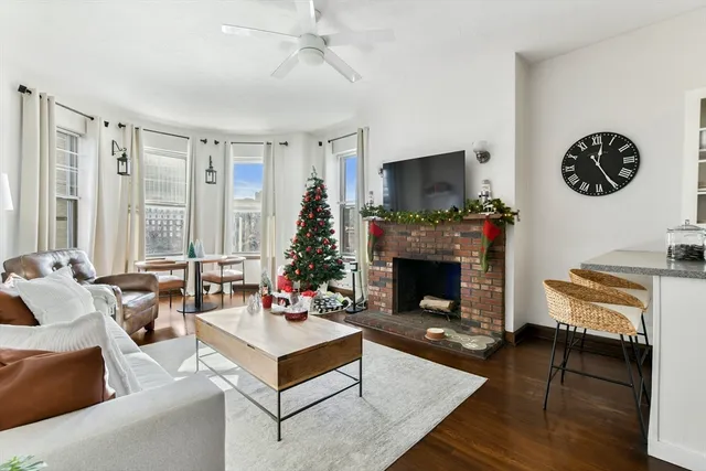 a living room with furniture a flat screen tv and a fireplace