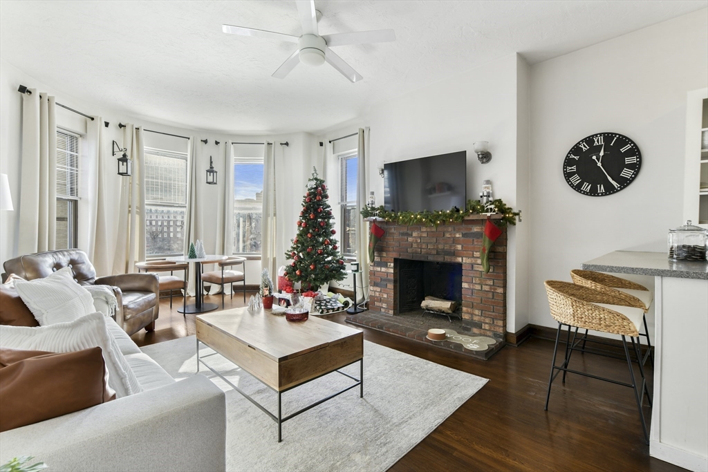 411 Marlborough Street, Unit 9 Boston, MA 02115 - Photo 3 of 20 a living room with furniture a flat screen tv and a fireplace