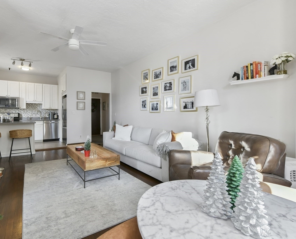 411 Marlborough Street, Unit 9 Boston, MA 02115 - Photo 5 of 20 a living room with furniture and a dining table with kitchen view