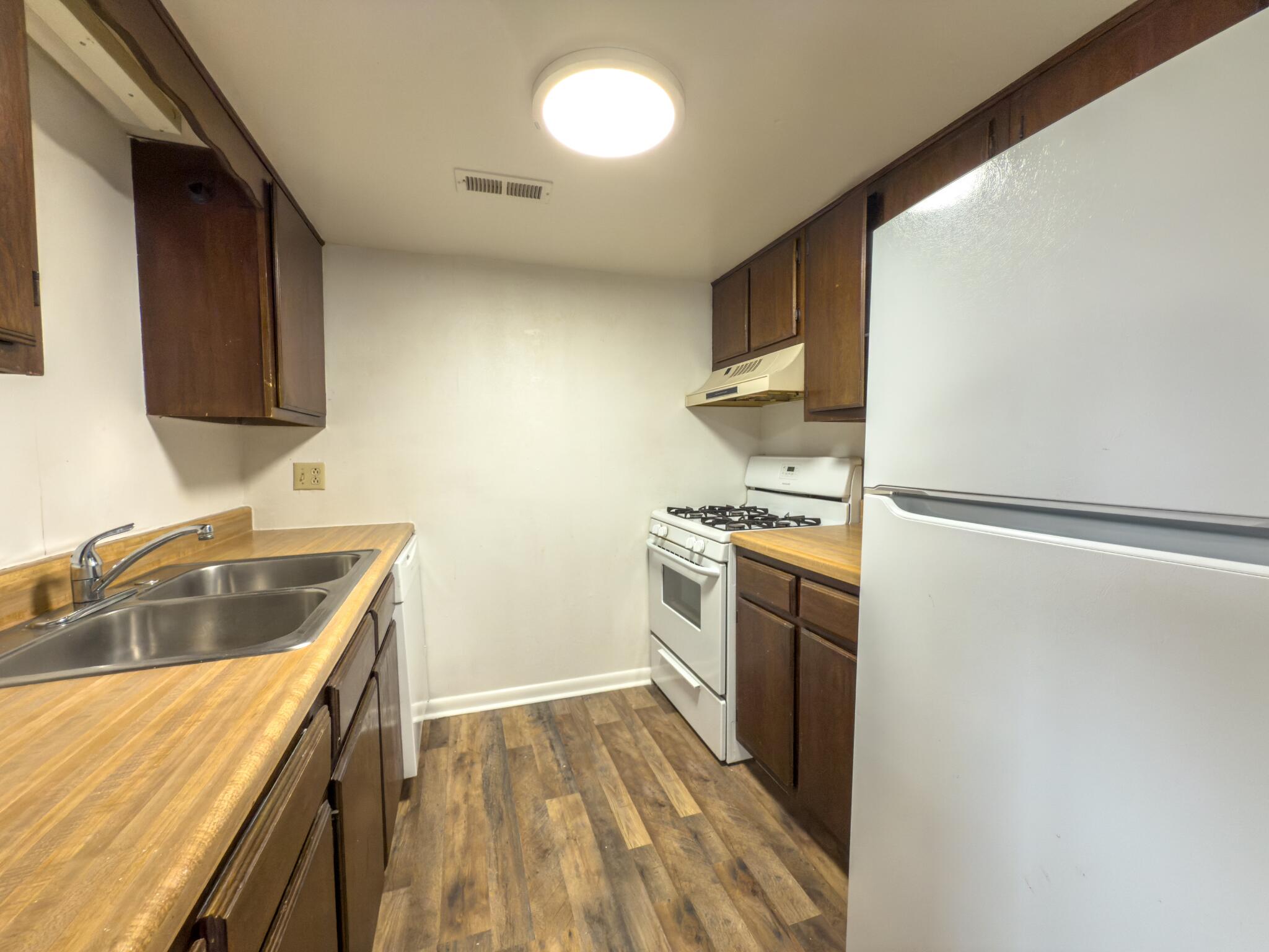 5131 Overland Drive, Unit A Roanoke, VA 24018 - Photo 4 of 9 a kitchen with a refrigerator stove and sink