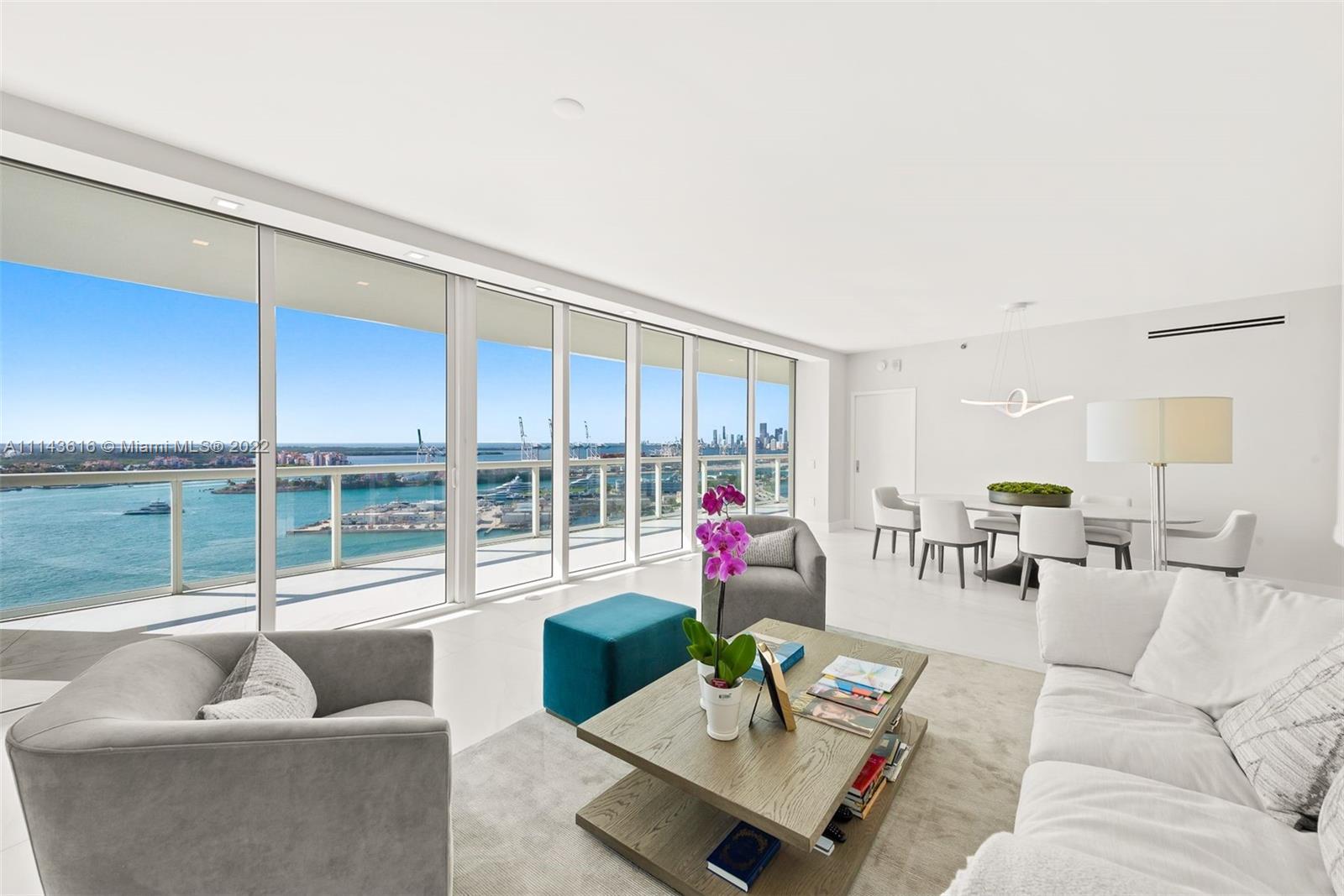 450 Alton Road, Unit 2301 Miami Beach, FL 33139 - Photo 1 of 21 a living room with furniture and a large window