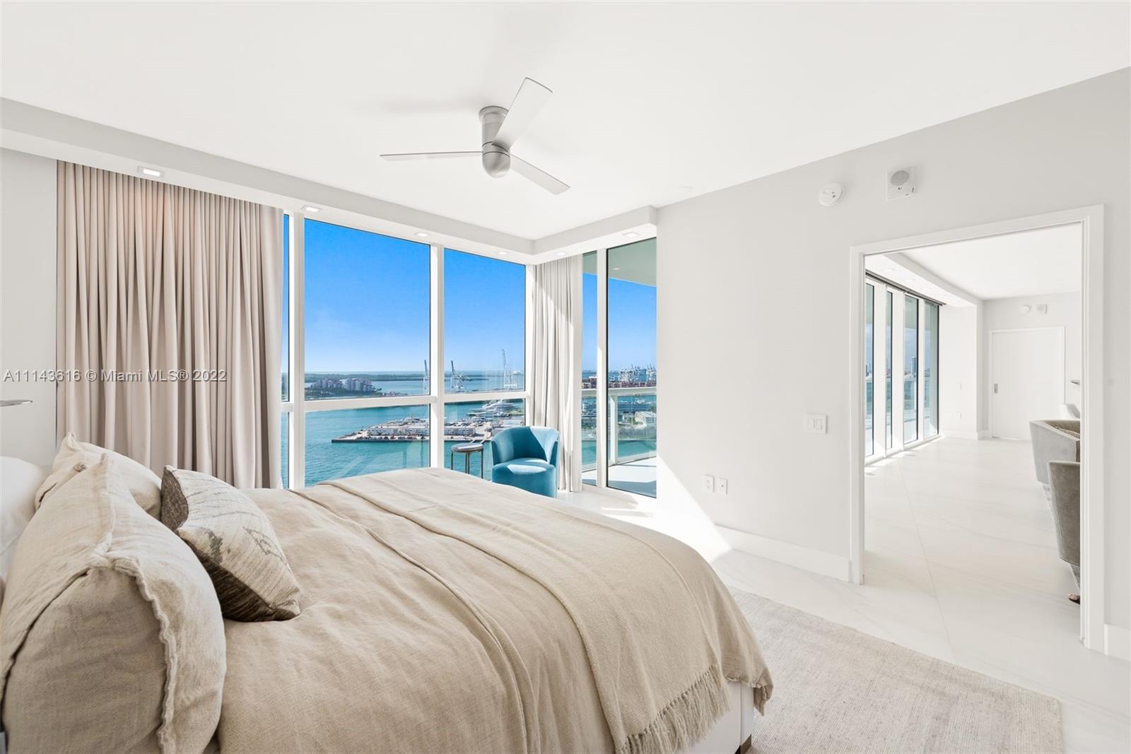 450 Alton Road, Unit 2301 Miami Beach, FL 33139 - Photo 12 of 21 a bedroom with a large bed and a chandelier