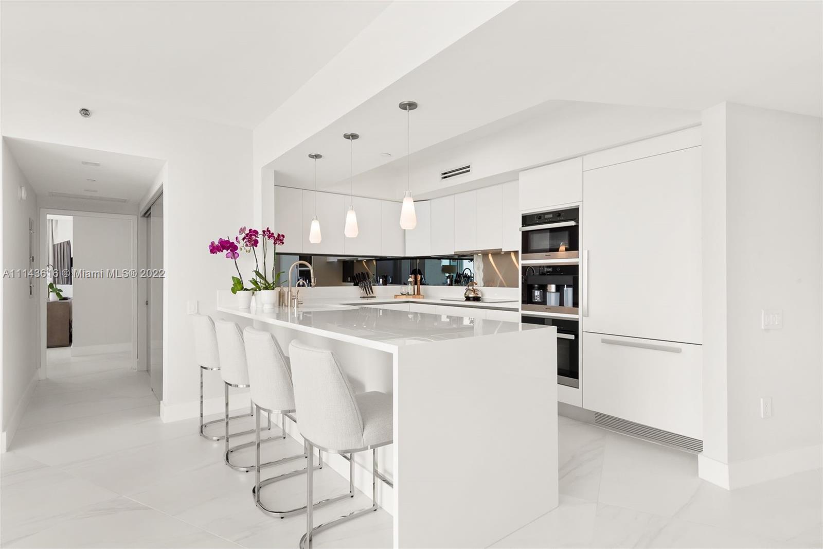 450 Alton Road, Unit 2301 Miami Beach, FL 33139 - Photo 4 of 21 a kitchen with stainless steel appliances kitchen island granite countertop a sink and cabinets