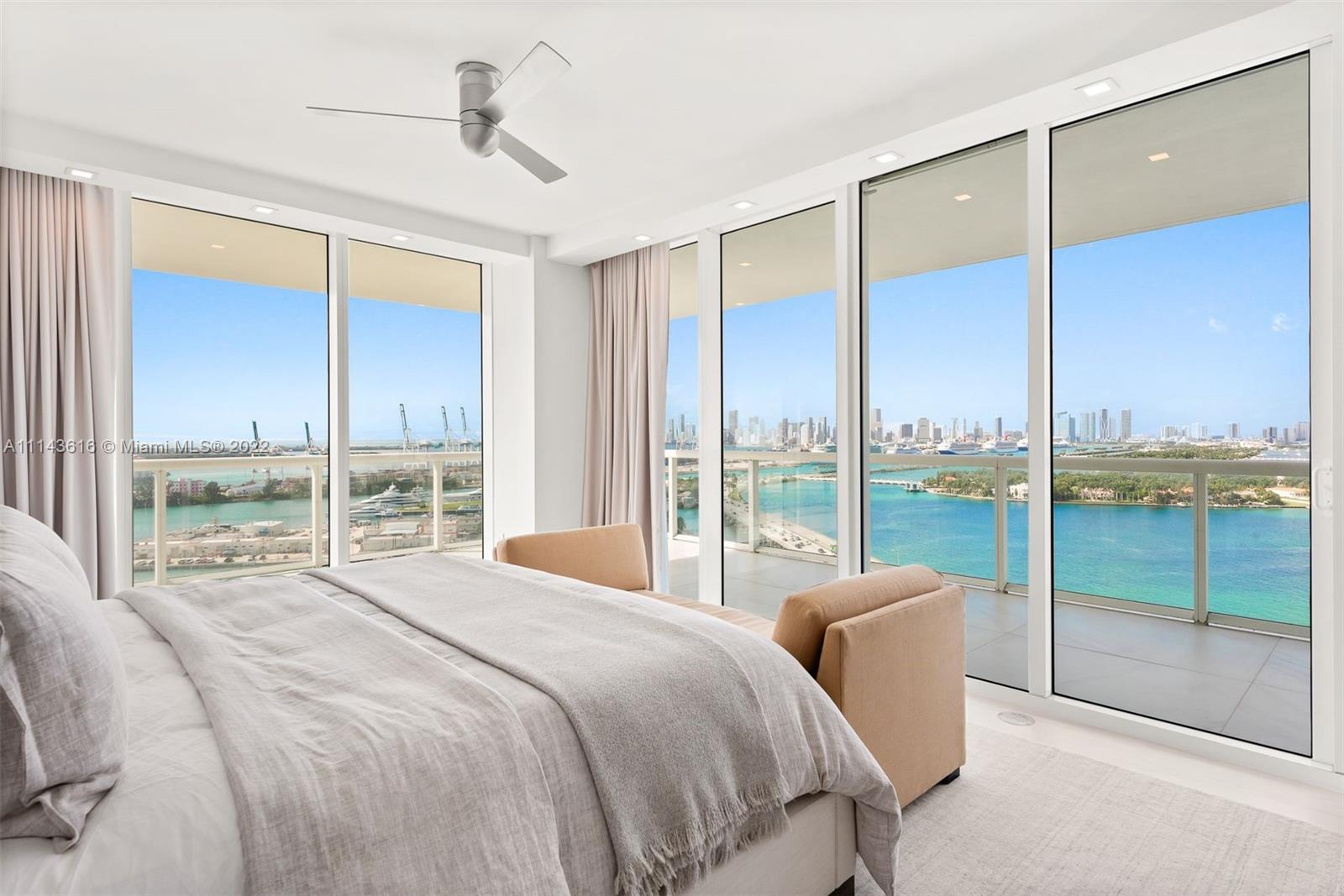 450 Alton Road, Unit 2301 Miami Beach, FL 33139 - Photo 10 of 21 a bedroom with a large window and a balcony